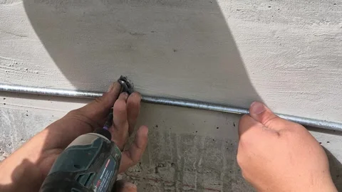 Worker Fixing Lightning Protection Wire on Exterior Wall Stock Footage 341104504