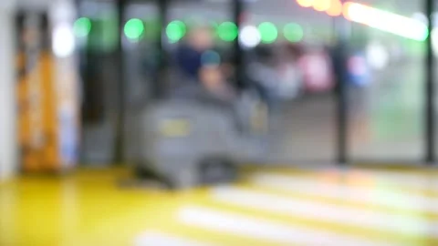 Worker on floor cleaning machine in a large shopping center cleans the floor Stock Footage 142021114