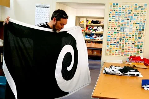 Worker fold the Koru flag Stock Photos