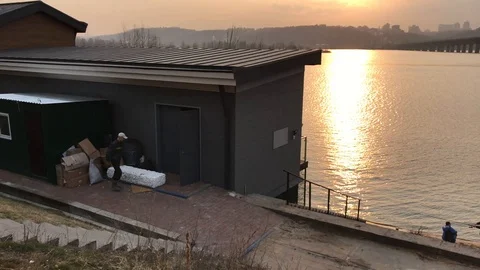 Worker folds boxes at sunset Video stock 111180641