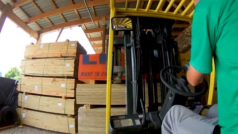 Worker on forklift in warehouse stocking building construction material Stock Footage 130580987