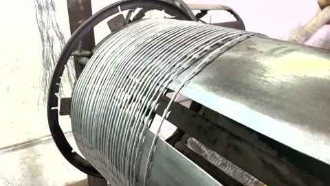 The worker forms a coil of metal wire on the machine, close-up Stock Footage 205474990