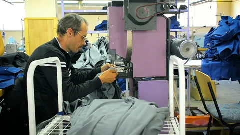 Worker at the garment factory perform an order for tailoring. Stock Footage 85483956