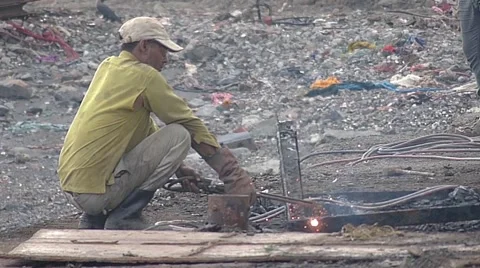 Worker gas cutting iron scrap parts Slowmo Stock Footage 53777425