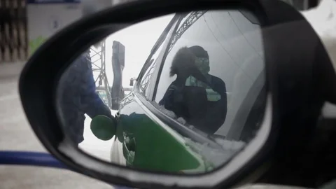 Worker of gas station refill a car. Car window view of refuel an auto Stock Footage 71006009