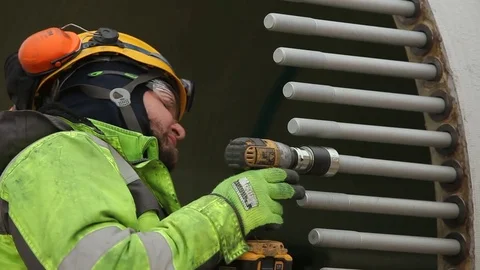 Worker in Glasses and Green Jacket Using Screw Gun Stock Footage 72397376