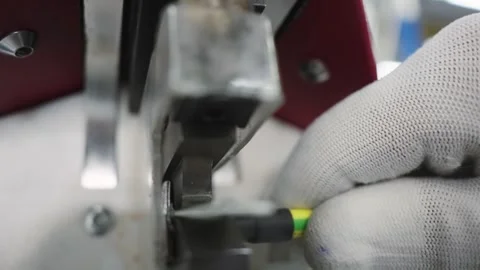 Worker gloved hands assembling crimp connector metal component in cable manuf Stock Footage 319503832