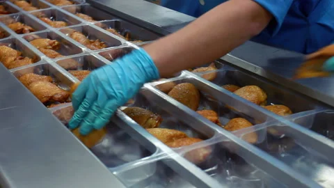 Worker gloved hands placing roasted chicken plastic tray. Poultry factory line. Vidéo 348676142