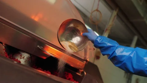 Worker in gloves adds spices to meat in machine in workshop Stock Footage 127272983