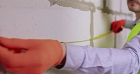Worker in gloves estimates distances using special equipment Stock Footage 309081806
