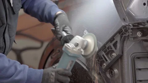 Worker with gloves passes the radial to a car he is repairing 스톡 동영상 239646307