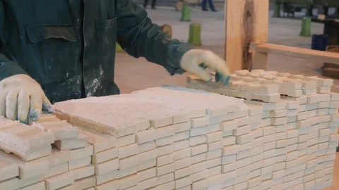 Worker in gloves puts white concrete bricks in pile closeup Stock Footage 124608321