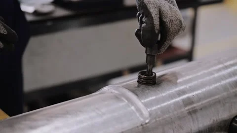 A worker in gloves screws the win into the drill. Repair of the oil pipe. Stock Footage 316162218