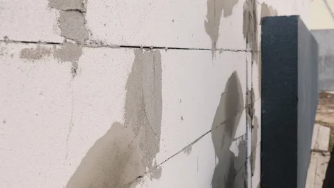 Worker glues insulation on the wall of the house Stock Footage 129331650