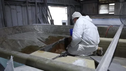 Worker gluing down Fiber Paper to a boat's frame 2 Stock Footage 162345681