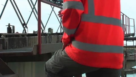 Worker goes on the metal construction. Video stock 95703717