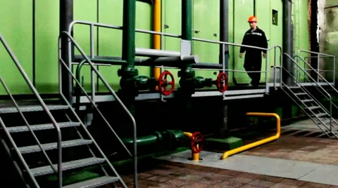 Worker Goes Platform And Lowered Inside Unit Stockbeeldmateriaal 10804684