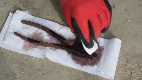 A worker greases old rusty wire cutters. Stock Footage 153307592