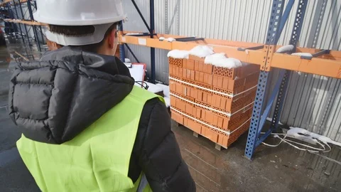 Worker in green, protective uniform cleaning storehouse Stock Footage 85562402