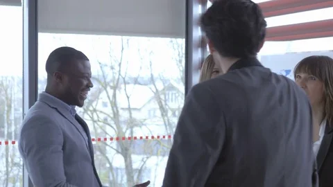 Worker greeting his friendly colleague with a high five Stockbeeldmateriaal 73884865