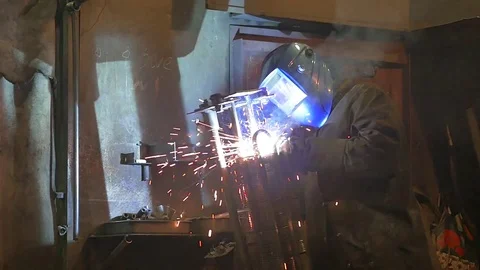 Worker grinding and welding in a factory. Welding on an industrial plant. Slow m Stock Footage