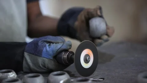 Worker grinding a casting ball part in factory. Industrial safety first concept. Stock Footage 297193915