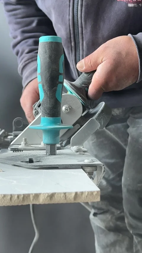 Worker Grinding Ceramic Tile Edge with Electric Angle Grinder Close Up Stock Footage 315090380