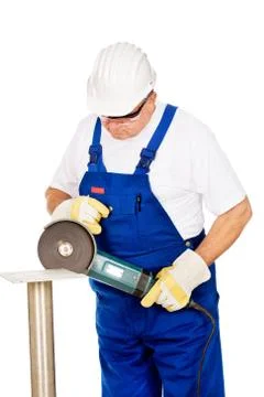 A worker grinding a chunk of iron Stock Photos