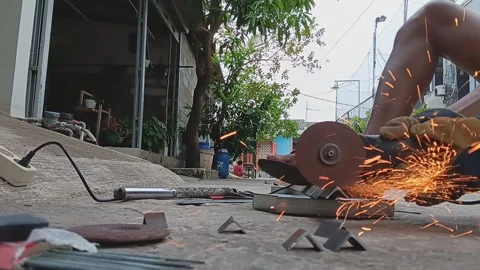 A worker is grinding iron Stock Footage 239984103