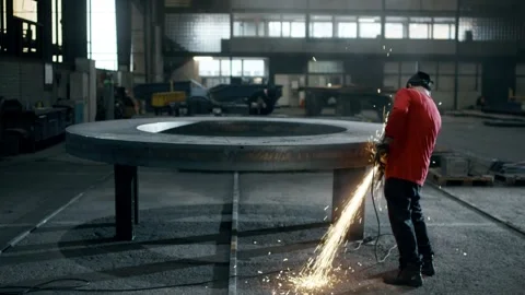 Worker Grinding a Large Steel Ring with Angle Grinder, Factory Hall, Wide Shot 動画素材 341530290