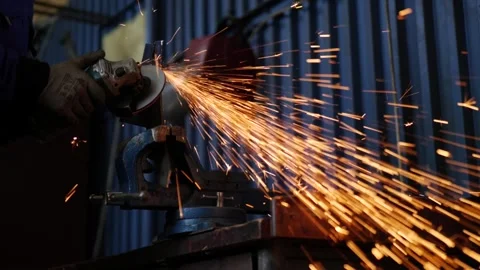Worker Grinding Metal with Angle Grinder in Industrial Workshop Stock Footage 306682416