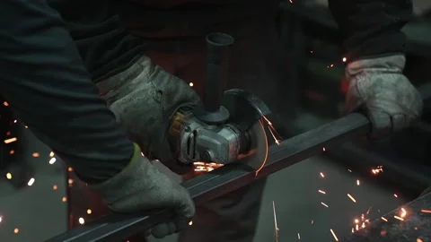 Worker Grinding Metal with Angle Grinder Stock Footage 308827875
