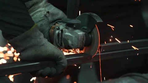 Worker Grinding Metal with Angle Grinder Stock Footage 308829146