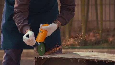 Worker Grinding Metal Beam With Orange Grinder Sparks Flying Video stock 336560345