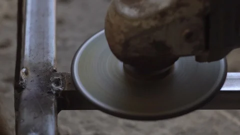 Worker grinding metal construction after welding Stock-Footage 105745083