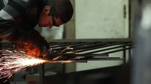 Worker grinding metal construction with a circular saw Stock Footage 72067764