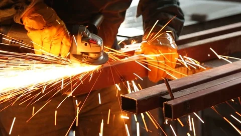 Worker Grinding Metal Construction with a Circular Saw Stock Footage
