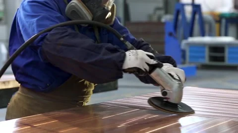 Worker is grinding a metal copper sheet at an industrial factory Stock Footage