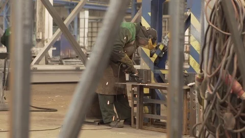Worker grinding metal in factory Stock Footage