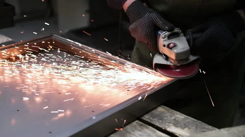 Worker grinding metal, metal grinding machine with sparks. Stock Footage 153580448