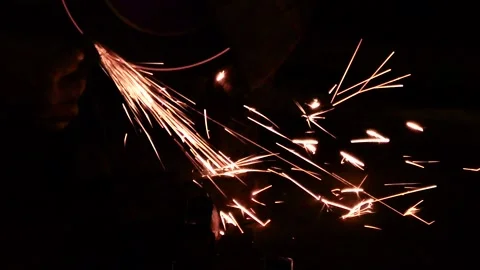 A Worker Grinding a Metal, Slow Motion Sparks Stock Footage 131183295