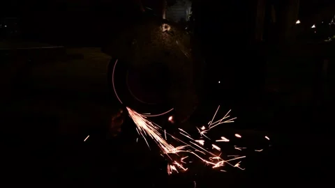 A Worker Grinding a Metal, Slow Motion Sparks Stock Footage 131184396