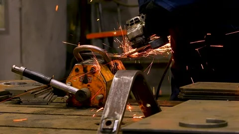 Worker grinding metal in a workshop. Stock Footage 341790024