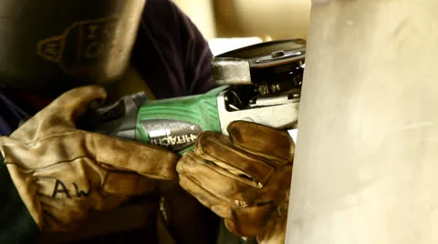 A worker grinding steel container Stock Footage 22615603