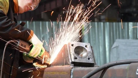 Worker grinding weld seam with grinder machine and sparks Stock Footage 84229800