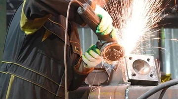 Worker grinding weld seam with grinder machine and sparks Stock Footage 85804386