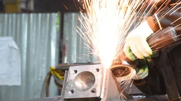 Worker grinding weld seam with grinder machine and sparks Stock Footage 85805988