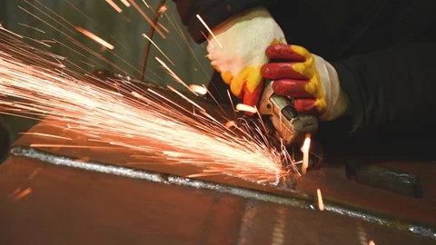 Worker grinding weld seam with grinder machine and sparks Stock Footage 91076846
