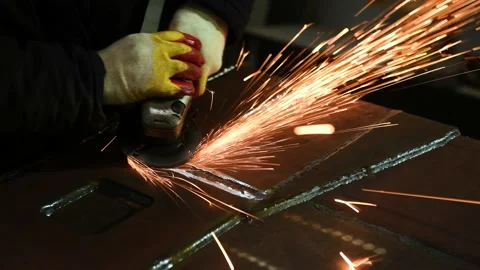 Worker grinding weld seam with grinder machine and sparks. 4k Stock Footage 131398325