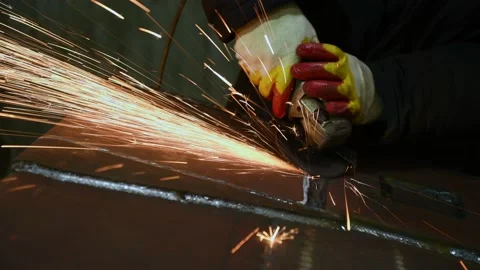 Worker grinding weld seam with grinder machine and sparks. 4k Video stock 131398403